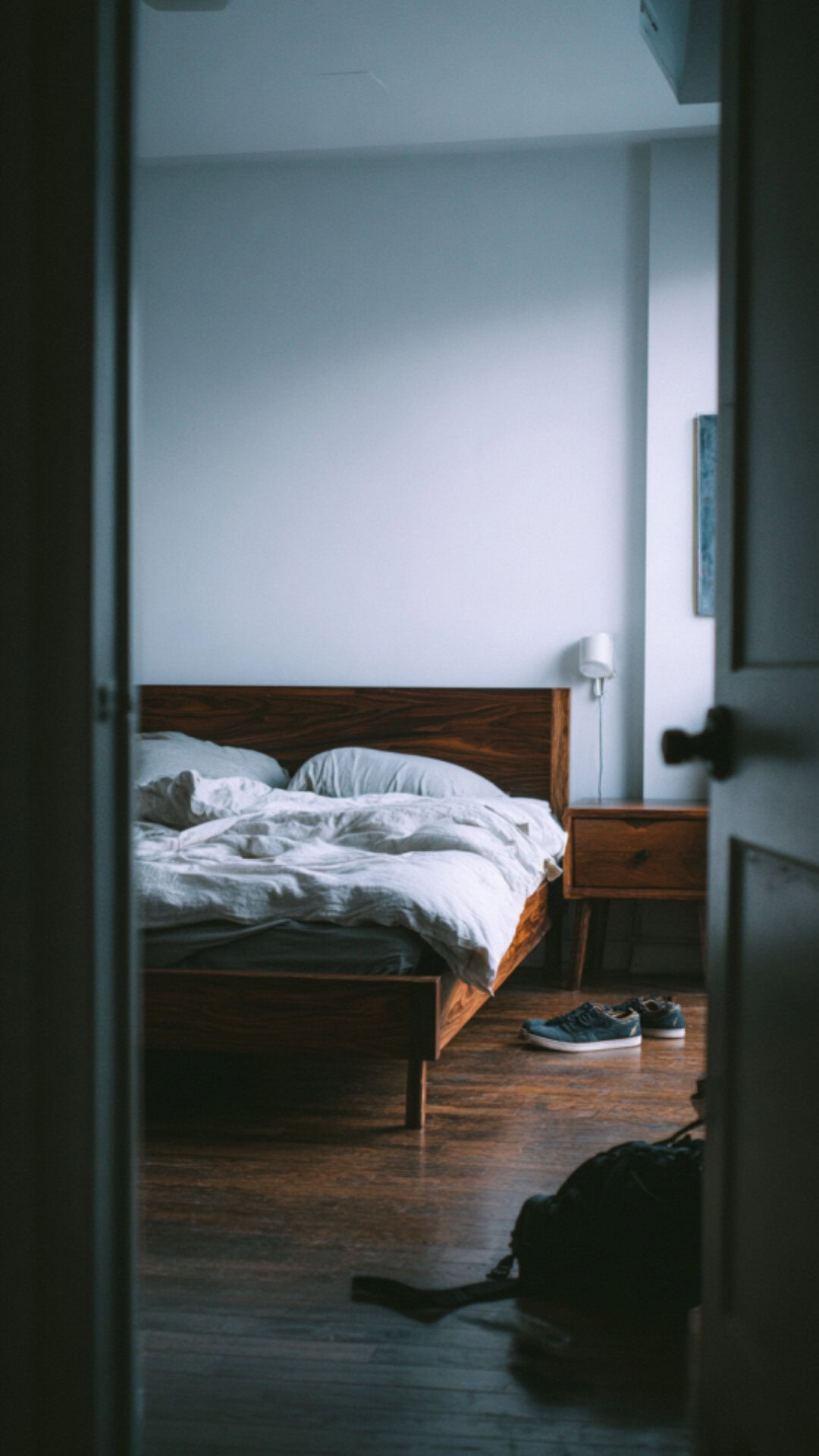 minimalist bedroom with dark wood elements
