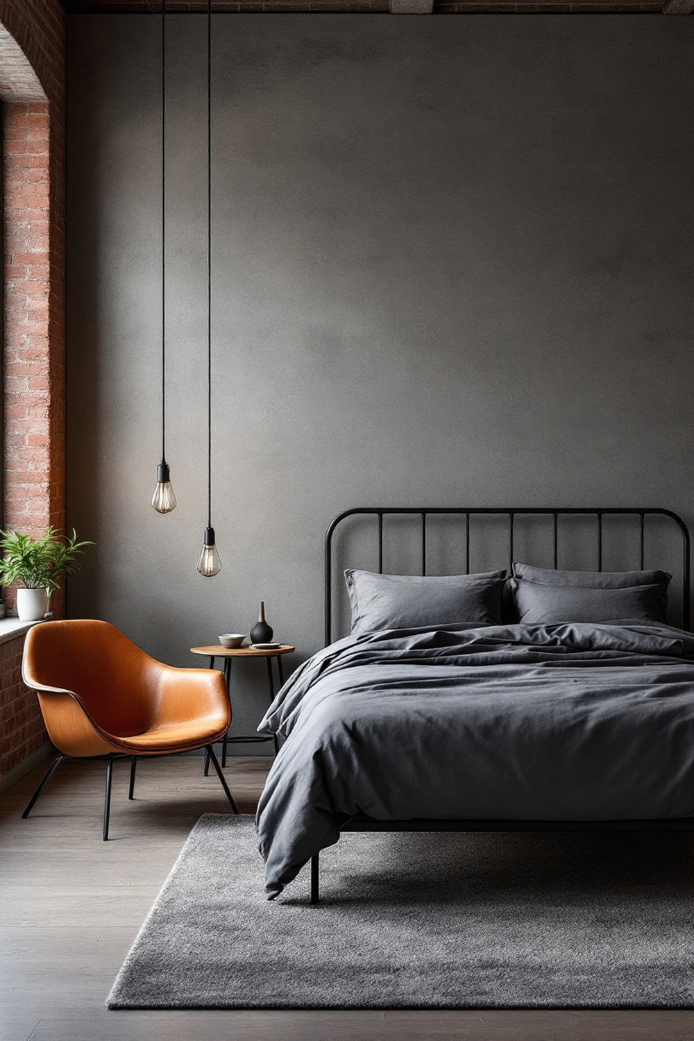 An industrial minimalist bedroom with a black metal bed frame, concrete wall, Edison pendants and a leather chair